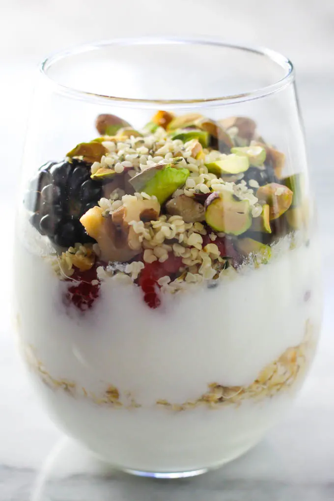 Fruit and nut healthy yogurt parfait in a glass.