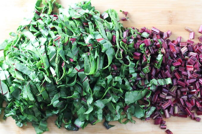 Chopped beet greens on a cutting board.