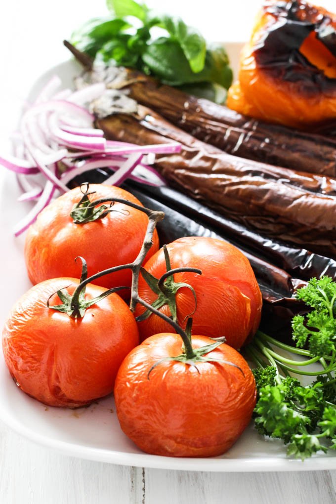 Armenian grilled vegetables on a white platter.