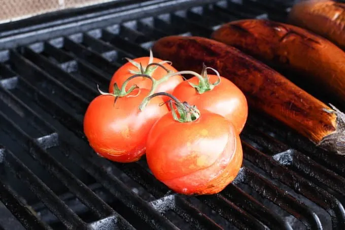 Tomatoes on an outdoor grill.