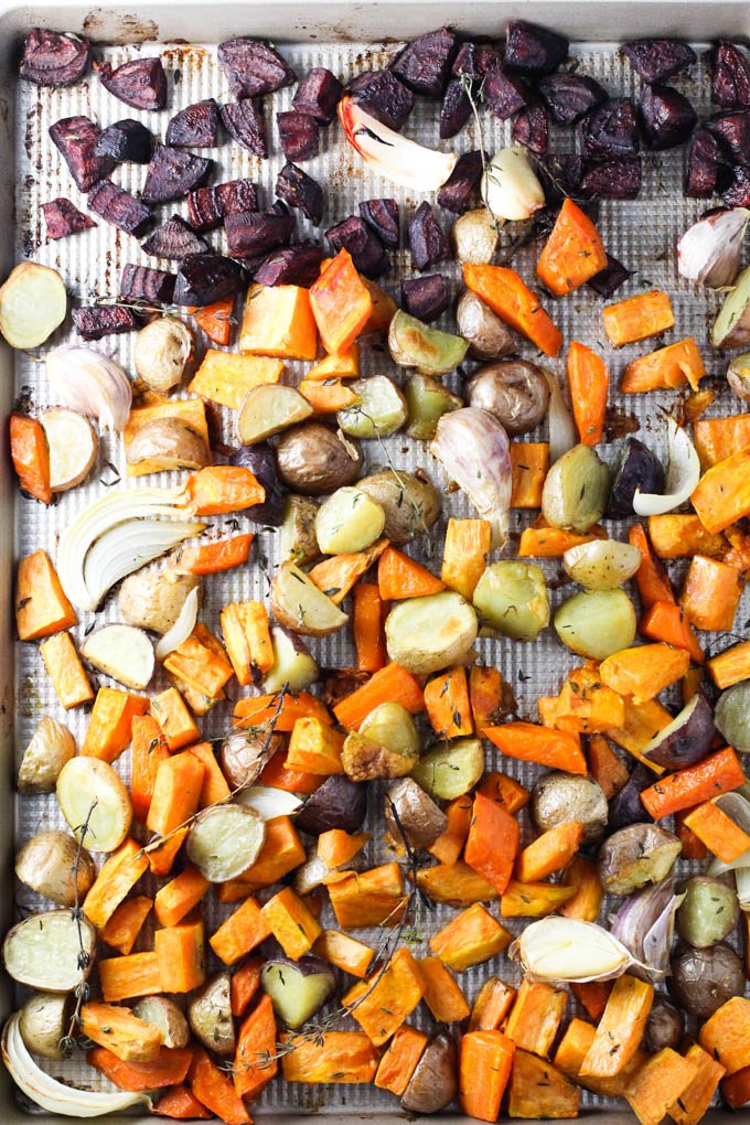 Roasted root vegetables on a baking sheet.