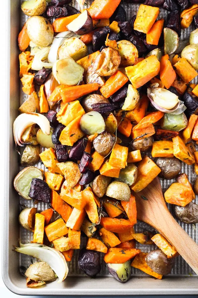 Roasted root vegetables on a sheet pan.