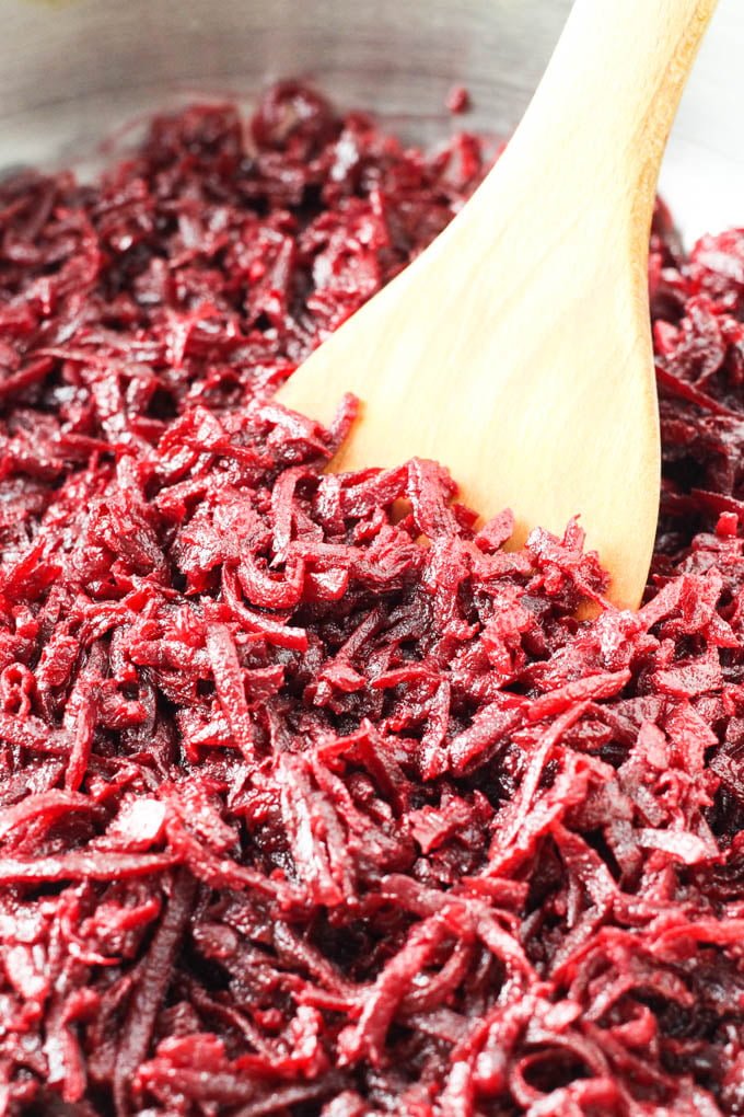 Shredded sauteed beets in a pan.