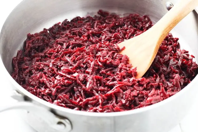 Shredded sauteed beets in a pan.