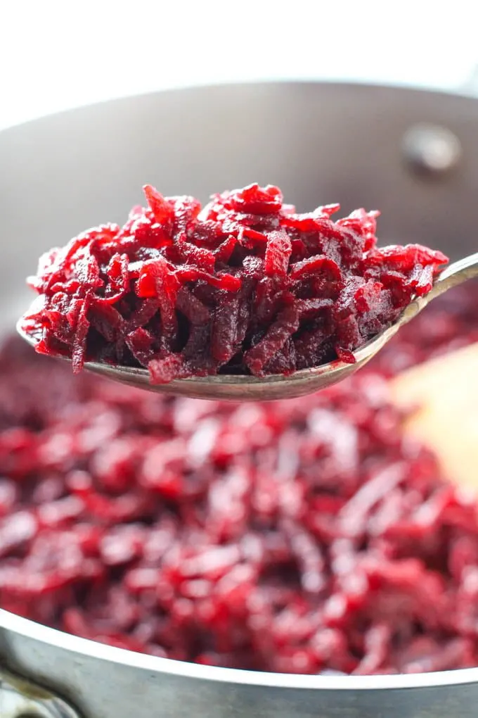 Shredded sauteed beets on a spoon.