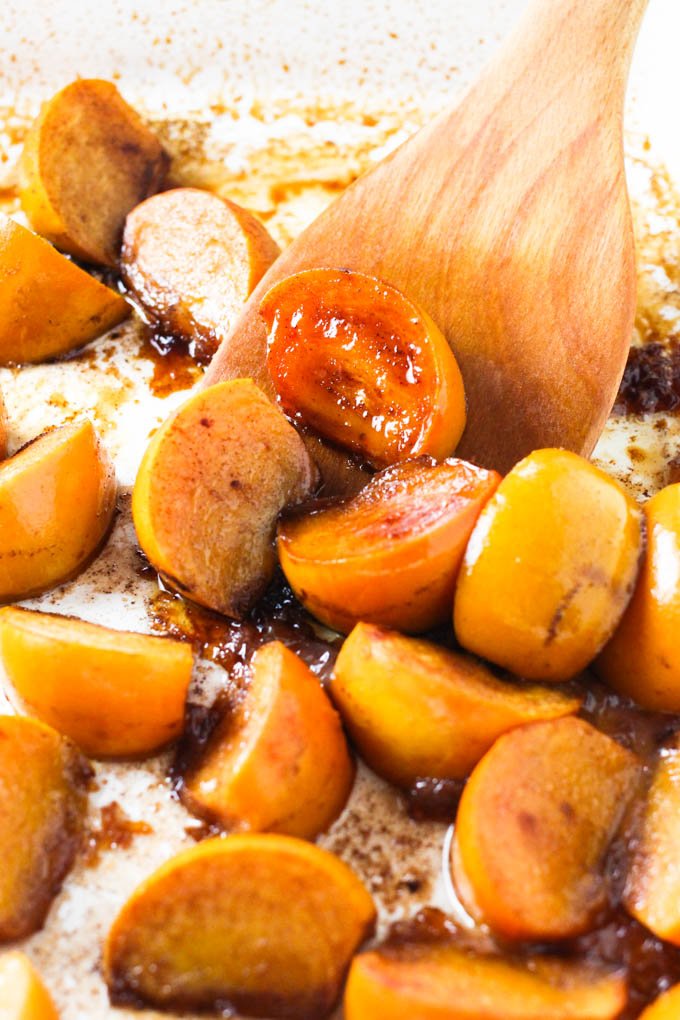 Close up shot of baked persimmons on a baking dish.