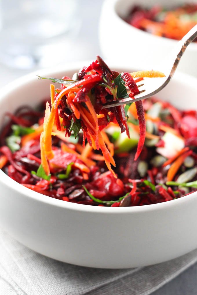 Beet and carrot pieces on a fork.