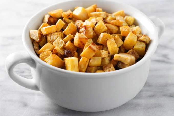 Roasted rutabaga in a white dish.