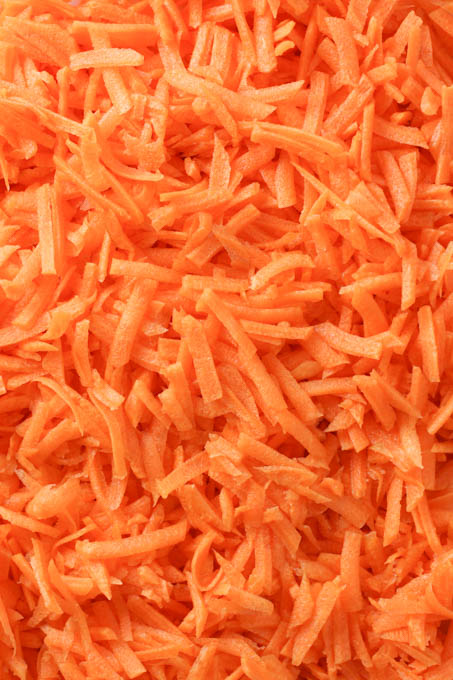 Close up shot of raw grated carrots.