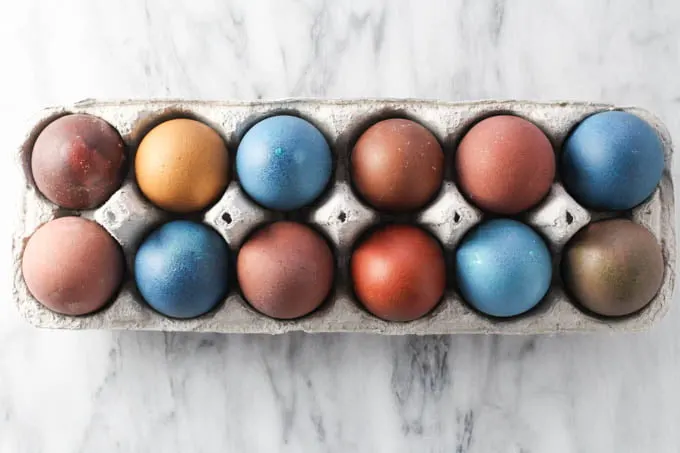 Multicolored Easter eggs in an egg carton.
