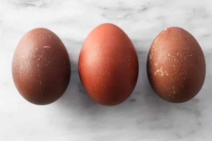 Three red and brown Easter eggs.
