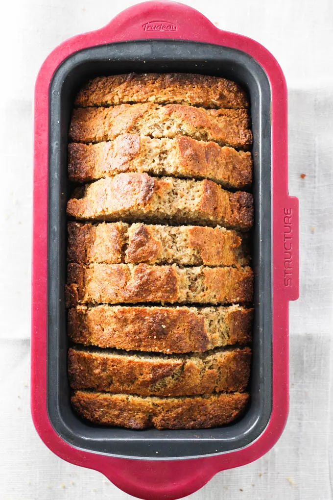 Spelt banana bread slices in a loaf pan. Top view.