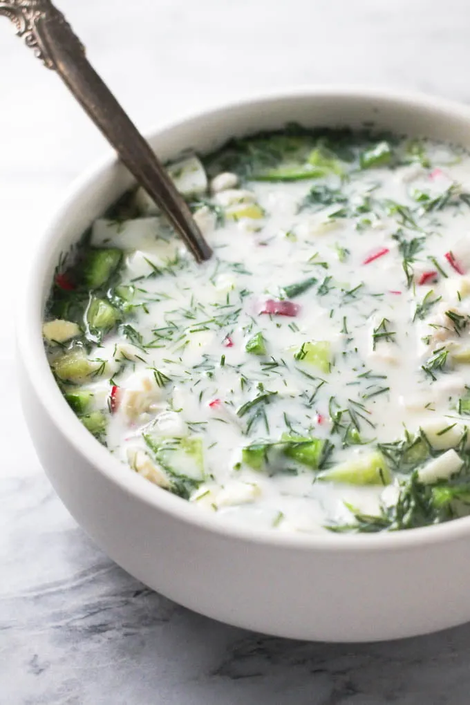 Okroshka soup in a white bowl.