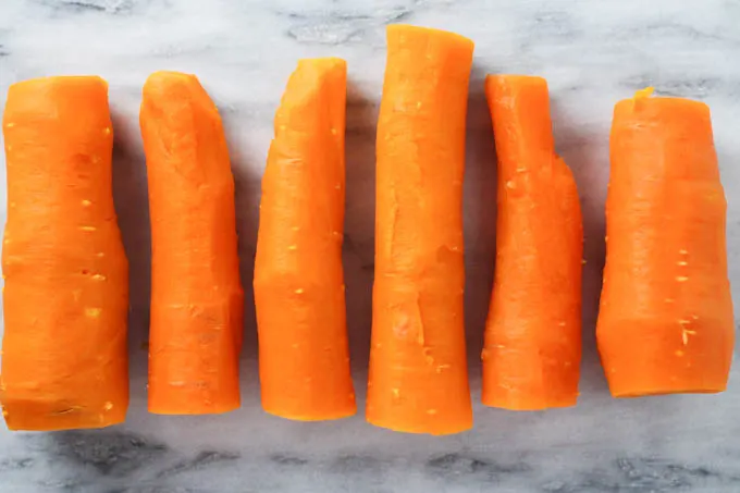 Boiled carrots on a marble background.