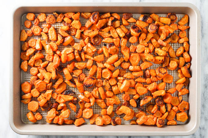 Roasted carrots on a baking sheet.