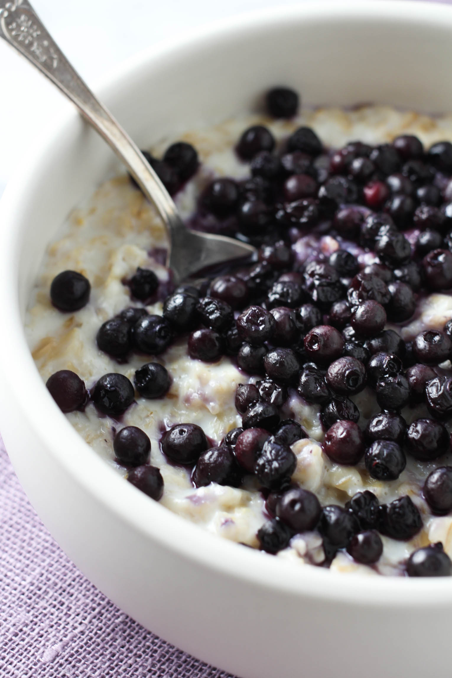 Oatmeal topped with blueberries in a bowl.