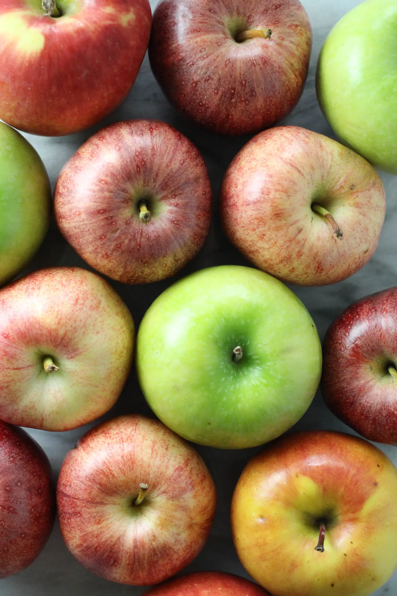 Overhead shot of red, green, and multicolored apples.