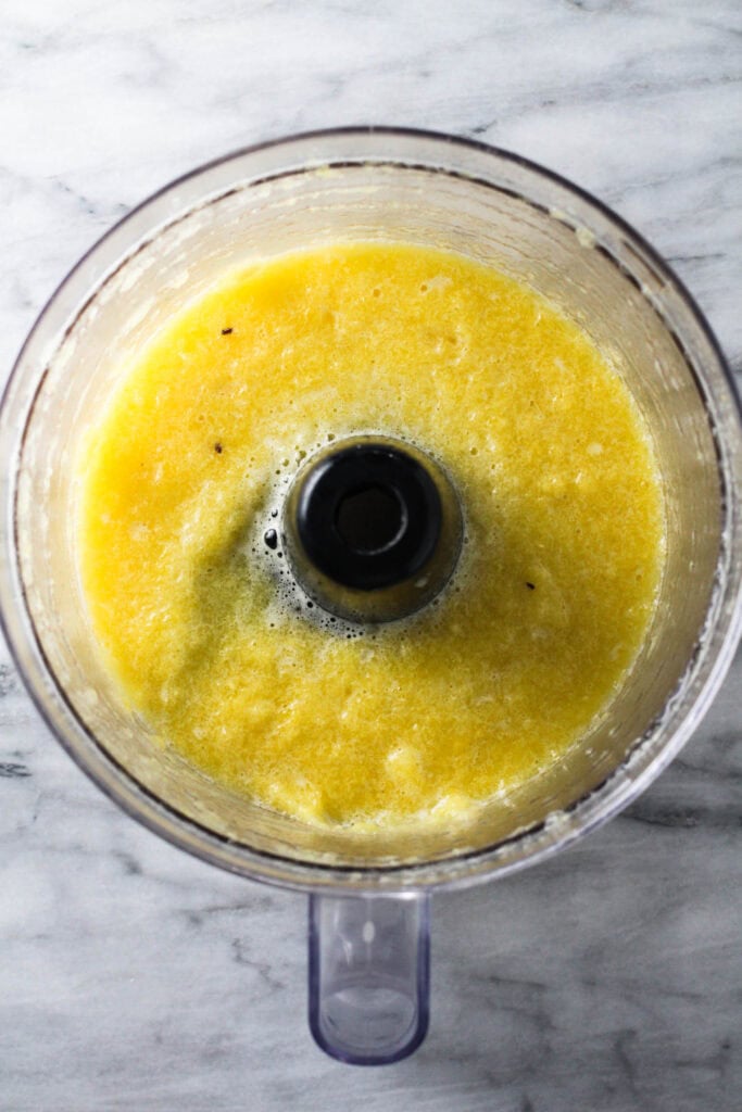 Pureed pineapple in a blender.