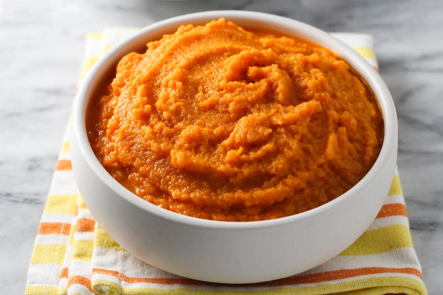 Mashed carrots in a bowl.