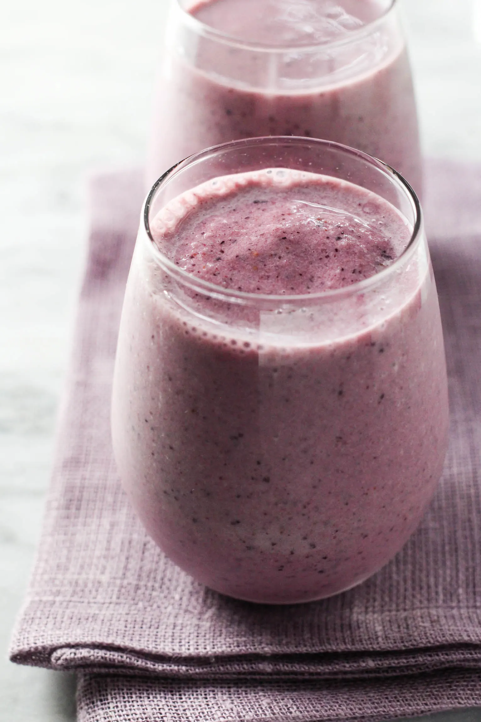 Strawberry Blueberry Banana Smoothie in a glass. Standing on a napkin.