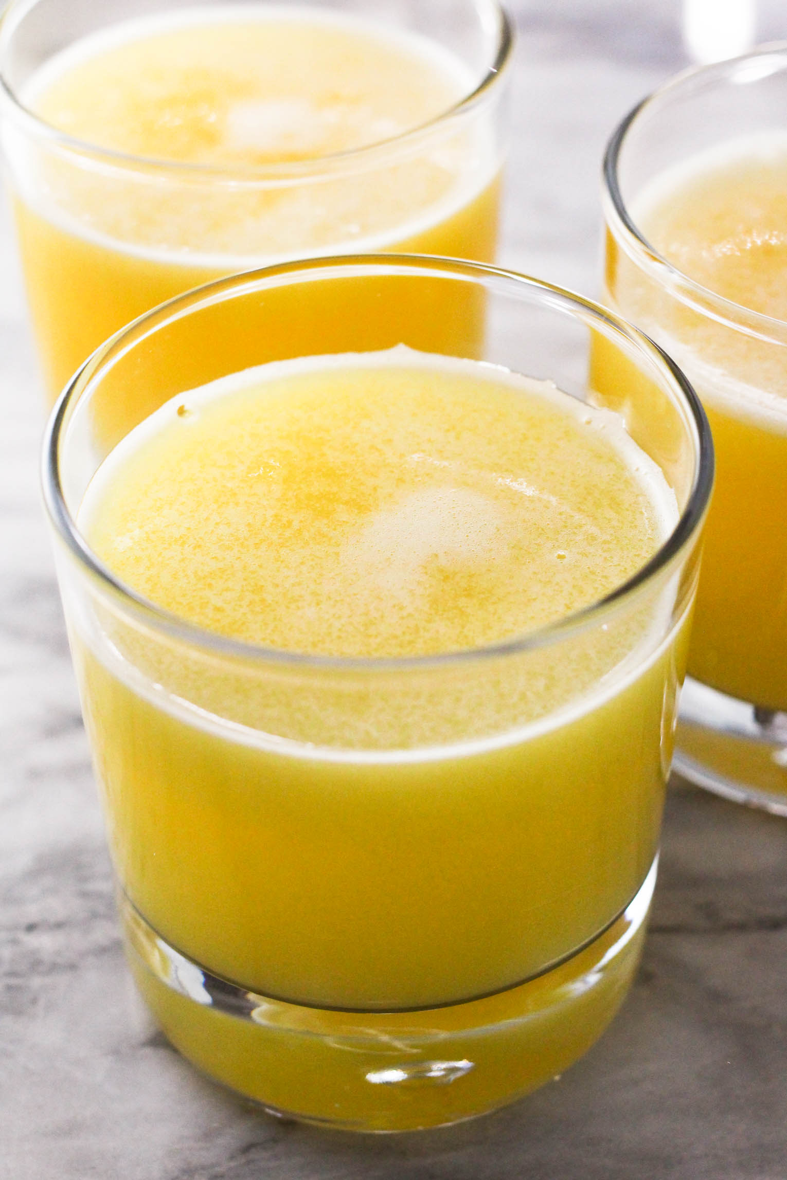 Three glasses of pineapple juice.