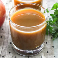 Homemade juice in a glass standing on a napkin.