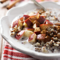 Quinoa with apple slices in a bowl.