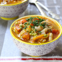 Chicken and white bean soup in a bowl.