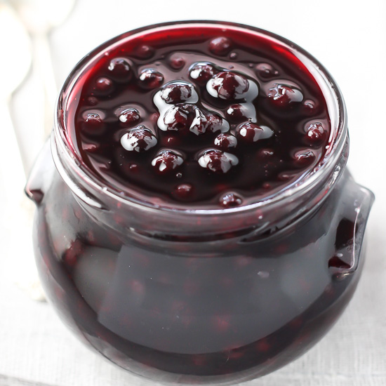 Blueberry sauce in a glass jar.