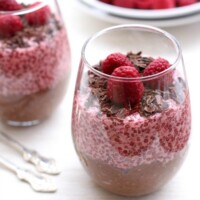 Chocolate and raspberry chia pudding in a glass.