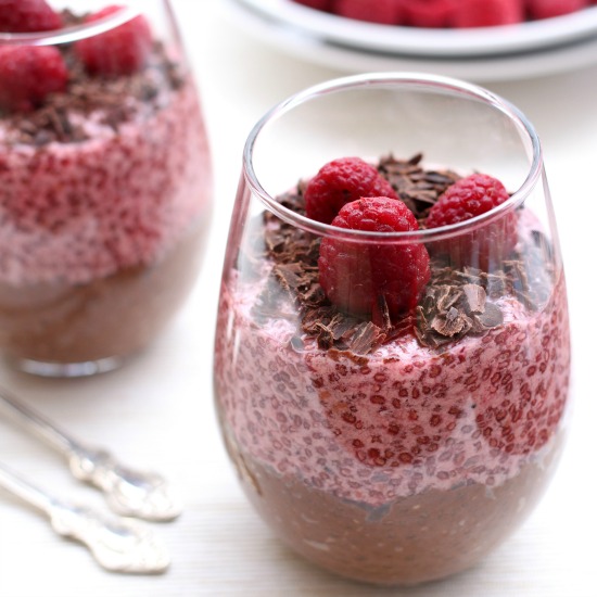 Chocolate and raspberry chia pudding in a glass.