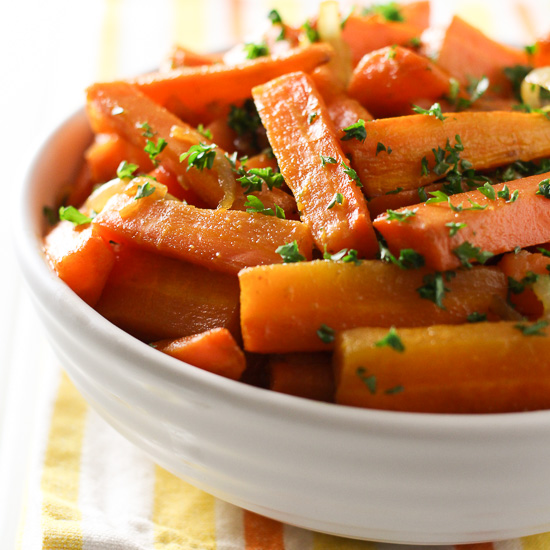 Roasted carrots and onions in a bowl.