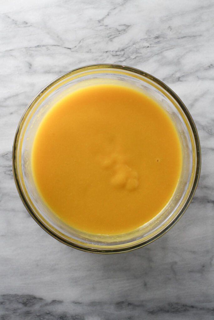 Mango puree in a glass bowl.