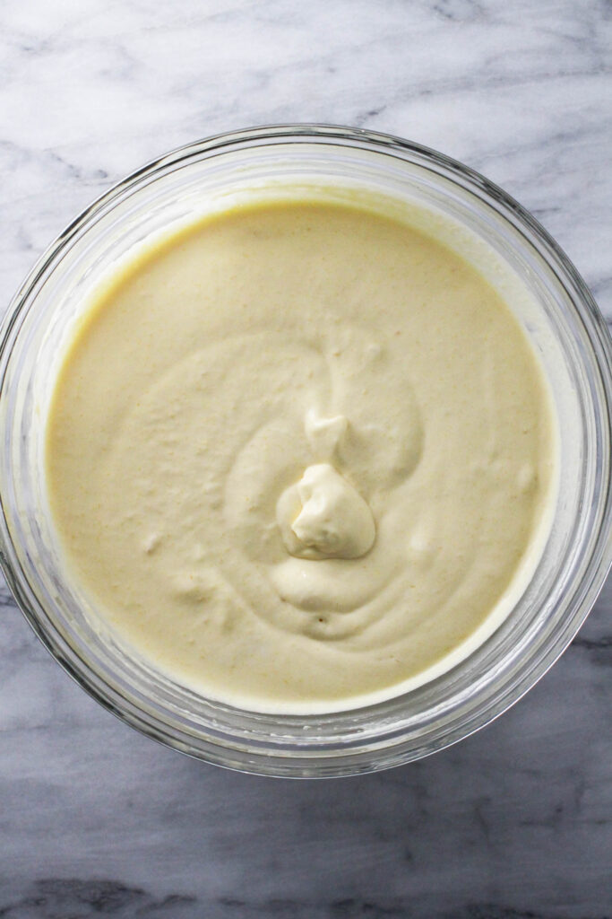 Whipped cream and mango mixture in a glass bowl.