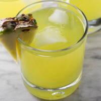Pineapple coconut water in a glass with ice cubes.