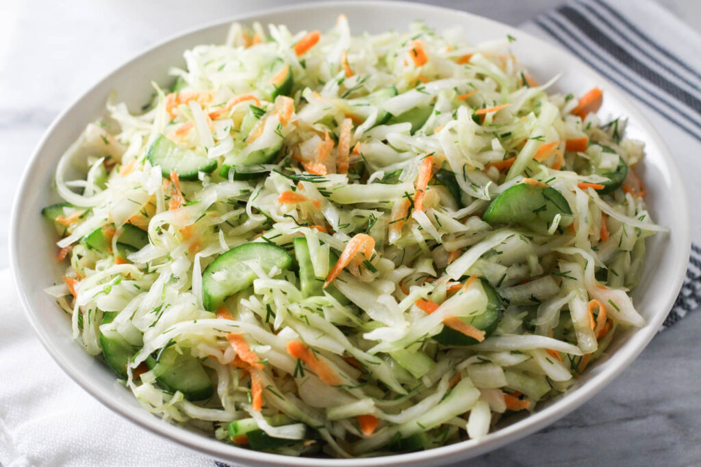 Close up shot of the cabbage cucumber salad in a bowl.