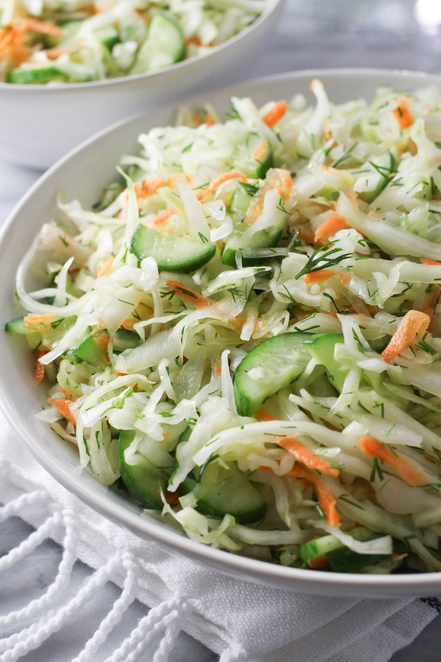 Close up shot of the cabbage cucumber salad in a bowl.