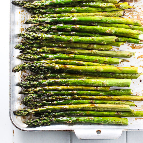 Roasted asparagus on a baking sheet.