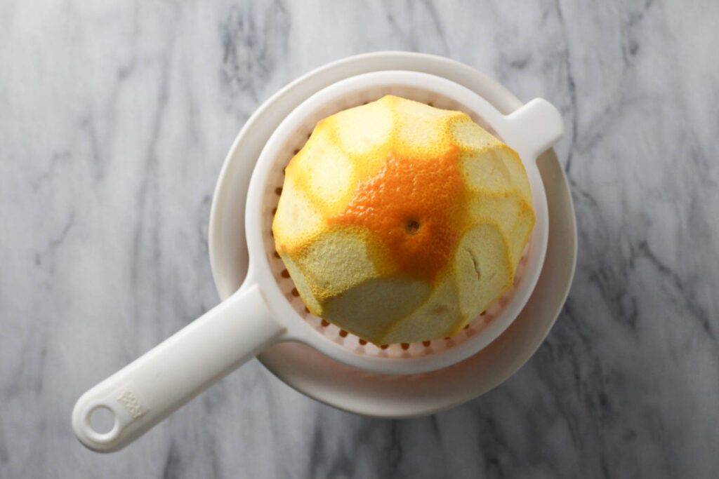 An orange being juiced.