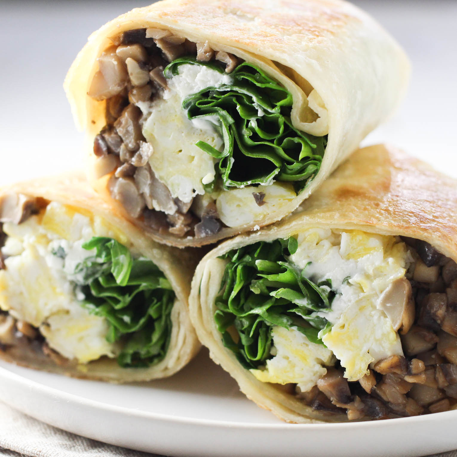 Sliced mushroom wrap on a plate.