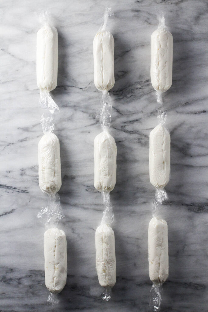 Cheese mixture bars wrapped into plastic wraps.