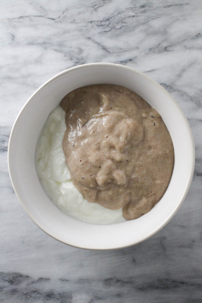 Banana puree and and yogurt in a bowl.