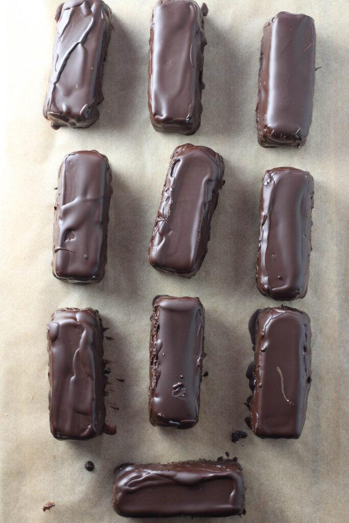 Chocolate glazed syrok bars on parchment paper.