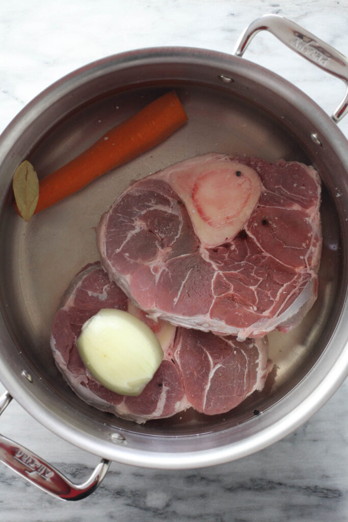 Beef broth ingredients in a soup pot.