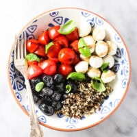 Caprese quinoa bowl on a plate.
