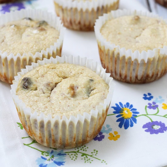 Mini cheesecake bites on a white surface with colorful floral embroidery.