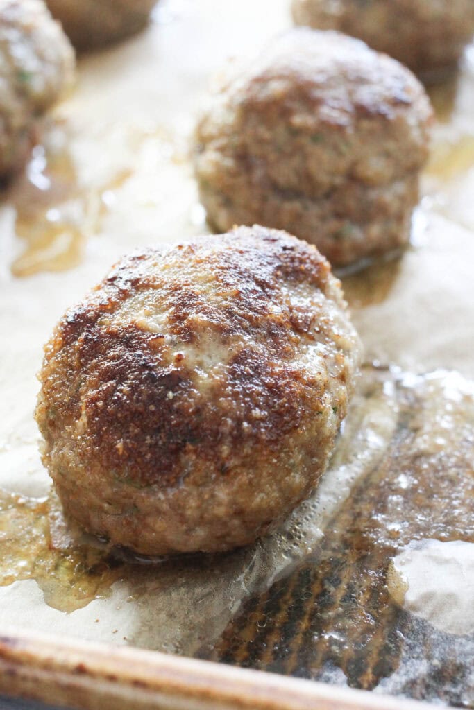 Close-up of baked kotlety with a golden brown crust.