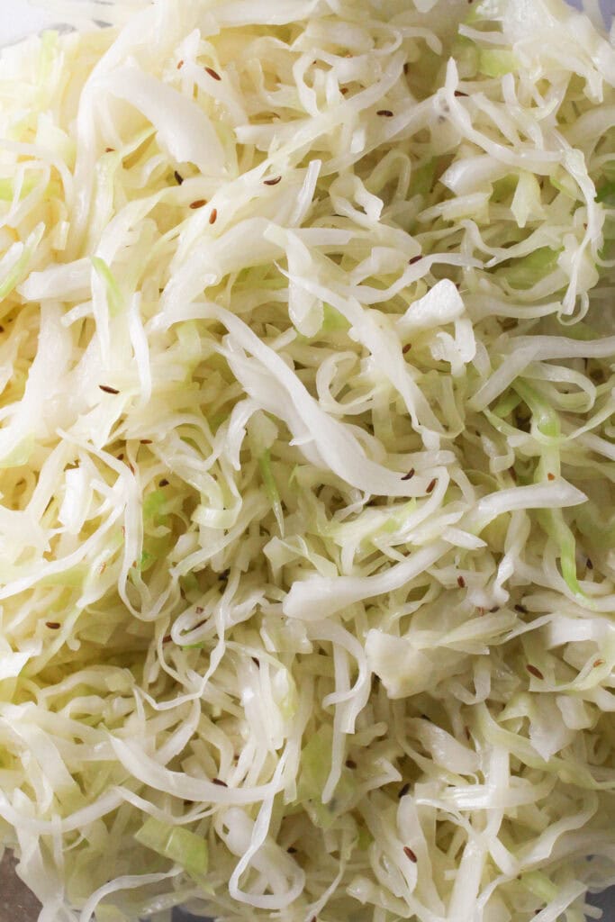 Close-up of traditional German Krautsalat cabbage salad with caraway seeds.