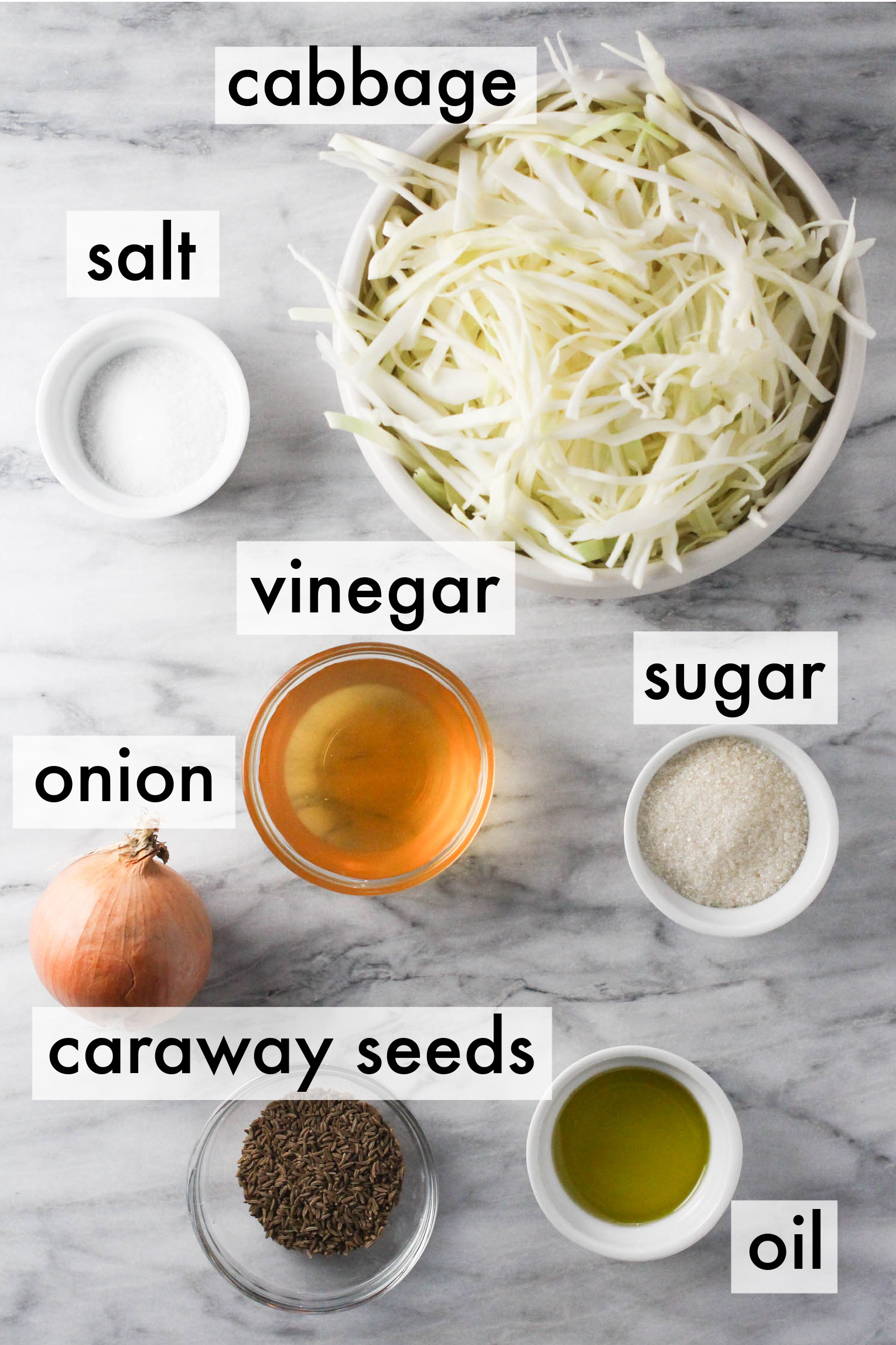 Ingredients for Krautsalat: cabbage, onion, vinegar, oil, salt, sugar and caraway seeds.