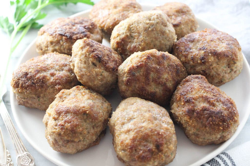Close-up of Russian meat cutlets (kotlety) arranged on a serving platter.